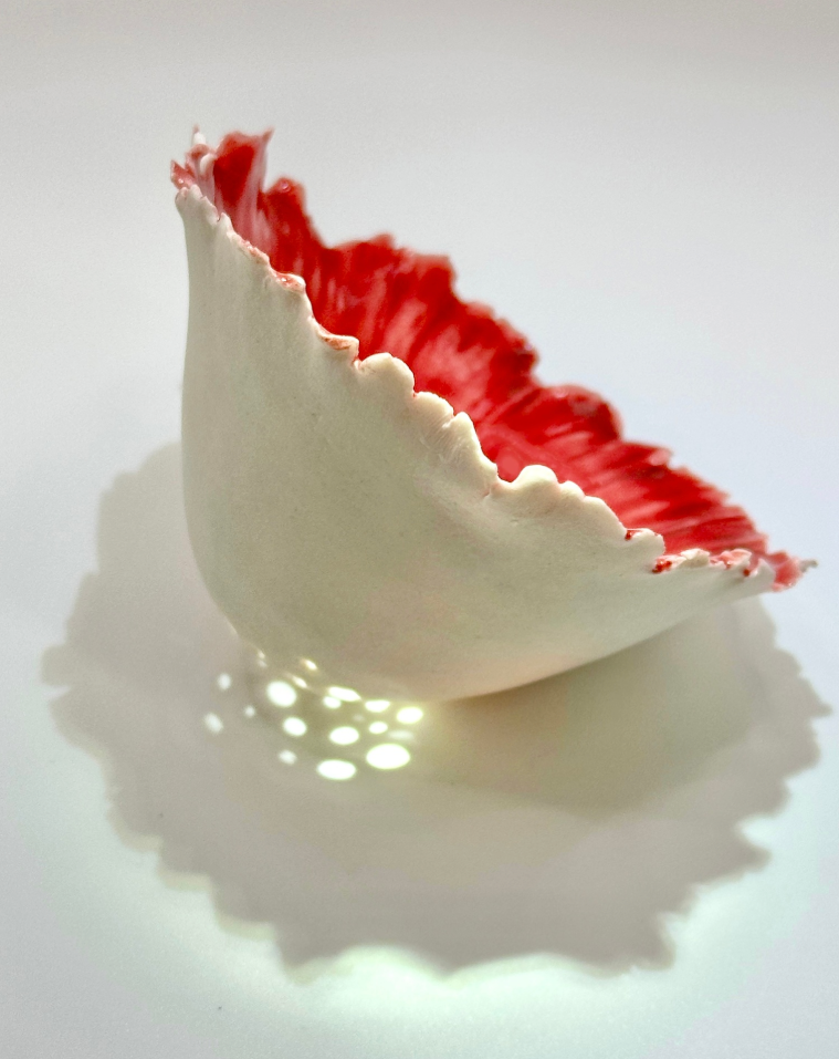White porcelain vessel with a red interior by Janna Carter